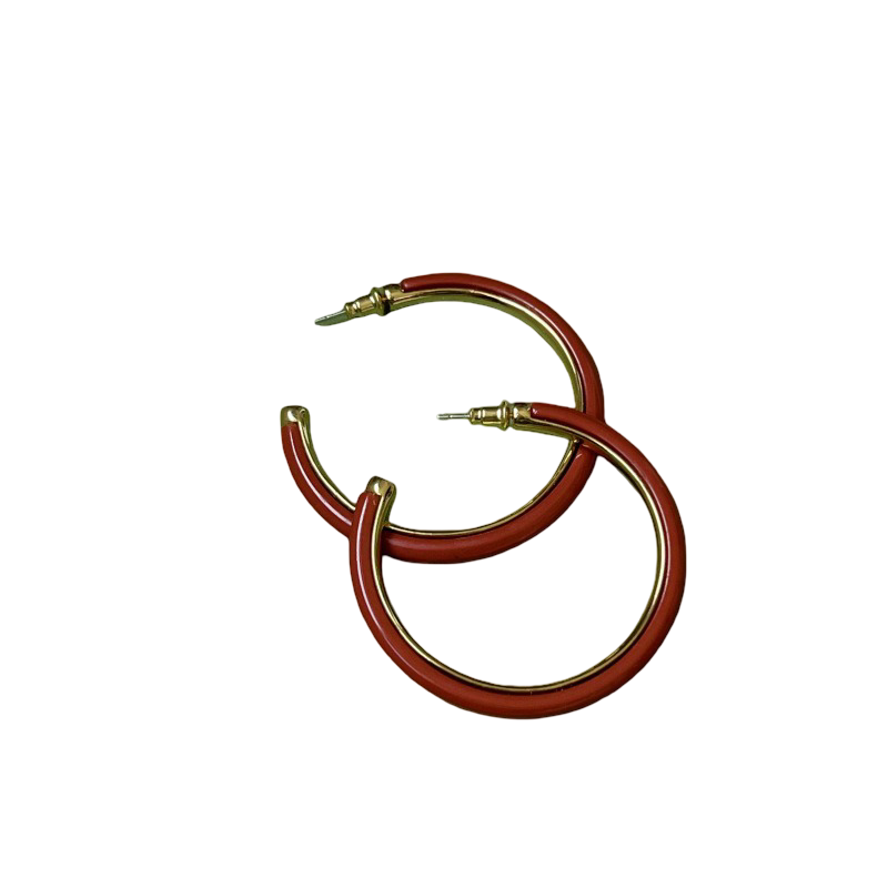 Pair of red hoop earrings with gold accents on a white background