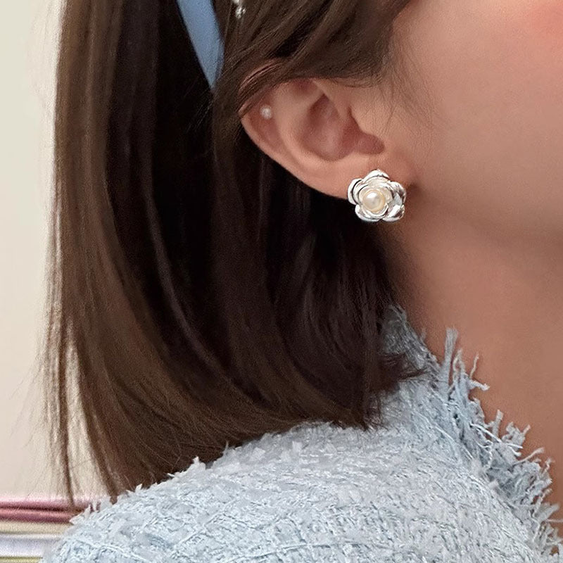 Pearl flower stud earrings on woman.